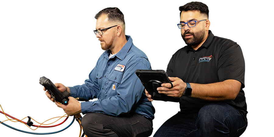Champion HVAC technicians holding tablet and tools